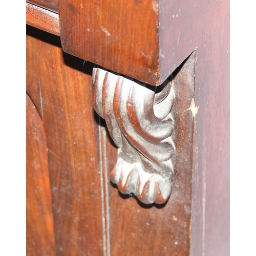 128 - A 19th century mahogany hall cupboard with well carved Fleur-de-Lys finial, single drawer over 2 cup... 