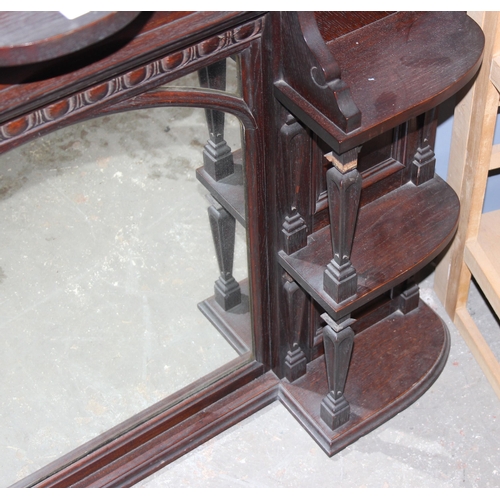 131 - Light wood folding book shelf & a carved mahogany framed over mantle mirror (2)