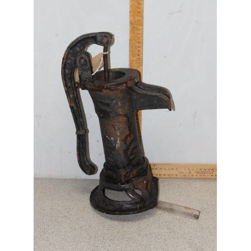 312 - A pair of miniature cast iron bench ends and a cast iron garden water pump