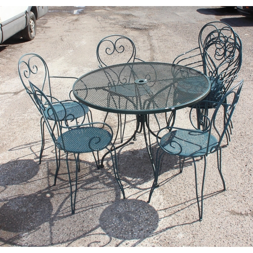 301 - A round garden table with a set of 8 matching wrought iron chairs