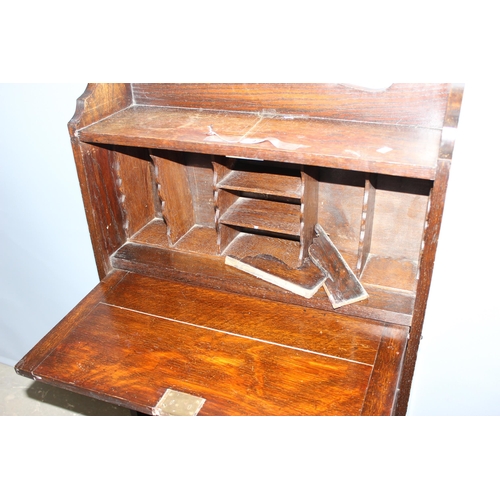 74 - An early 20th century oak student's bureau approx 60cm wide and a vintage Art Deco period oak bookca... 