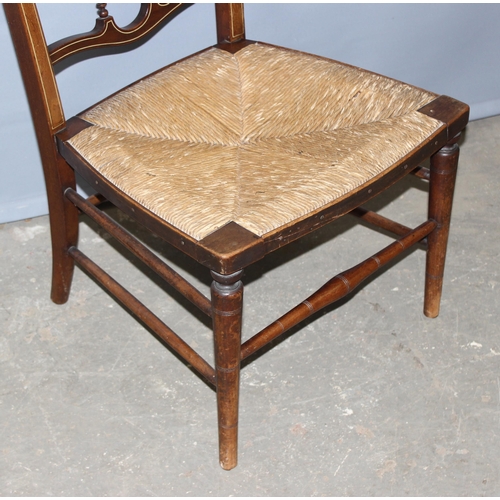 96 - An early 20th century bedroom chair with strung inlay and rush seat