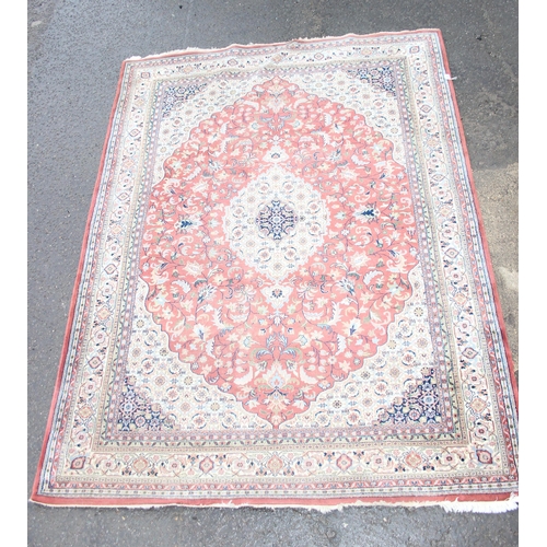 200 - A large Indo-Persian rug of pink/ red ground with various decorative borders, approx 335cm x 224cm, ... 