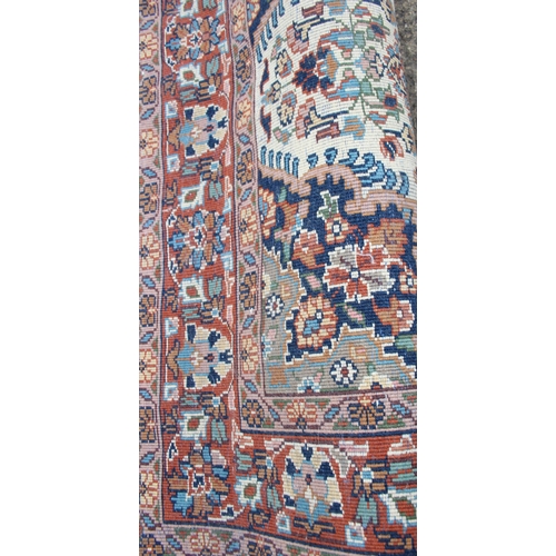 201 - A decorative cream ground Persian rug with colourful motifs, approx 160cm x 93cm