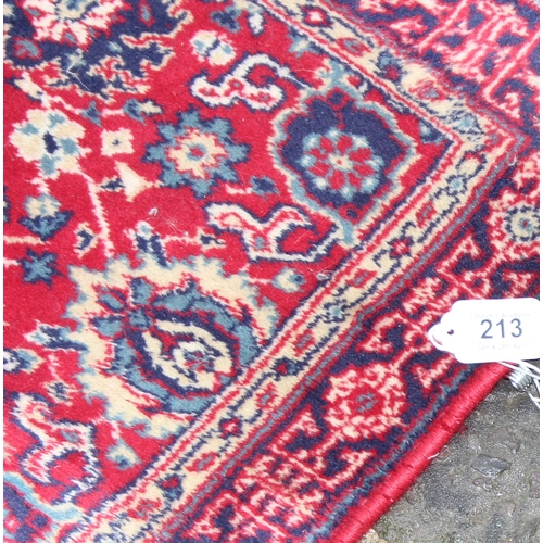 213 - A vintage red ground Basra runner rug, approx 240cm x 66cm