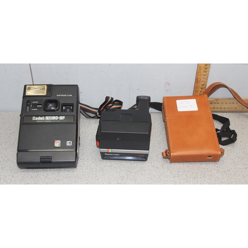 711 - 3 assorted polaroid cameras to include a Polariod SX-70 land camera model 2 and a Supercolour 635