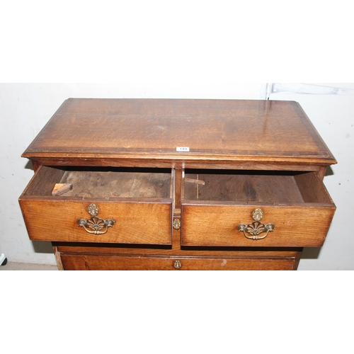 149 - An antique oak 2 over 3 chest of drawers with brass handles, approx 96cm wide