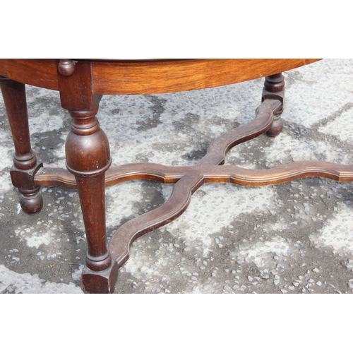 153 - An antique French oval table with extending leaf, approx 122cm wide