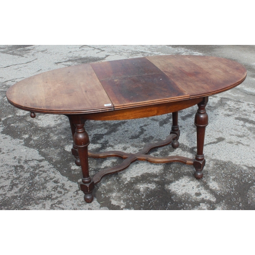 153 - An antique French oval table with extending leaf, approx 122cm wide