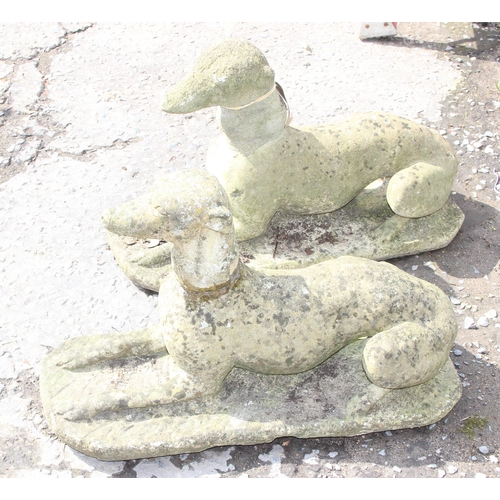 300 - A large pair of weathered concrete garden greyhound figures, approx 76cm wide