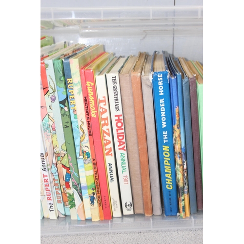 574 - A large qty of assorted vintage and later children's annuals to inc Rupert Bear etc