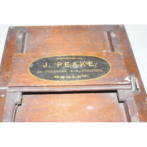 292 - An unusual wooden cased item manufactured for J. Peake of 23 Piccadilly & 4 Cheapside Hanley, possin... 