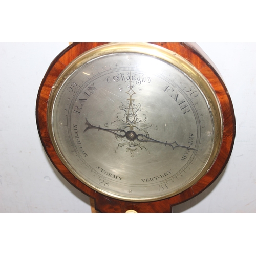 1314 - A 19th century mahogany cased wheel barometer, the broken swan neck pediment above a hygrometer, the... 