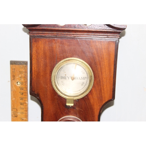 1314 - A 19th century mahogany cased wheel barometer, the broken swan neck pediment above a hygrometer, the... 