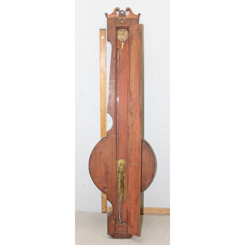 1314 - A 19th century mahogany cased wheel barometer, the broken swan neck pediment above a hygrometer, the... 