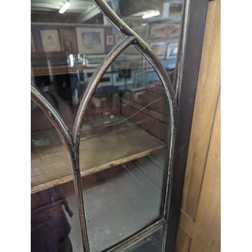 105 - Antique mahogany glazed bookcase over large shelved cupboard, approx 220cm