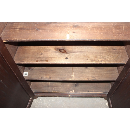 17 - An early 20th century bookcase or hall cupboard with 3 shelves, carved details and original key, app... 