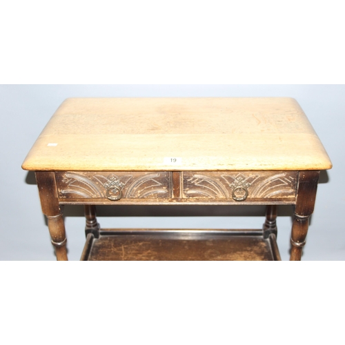 19 - An Ercol or Old Charm oak console table with 2 drawers, approx 69cm wide