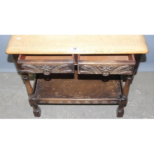 19 - An Ercol or Old Charm oak console table with 2 drawers, approx 69cm wide