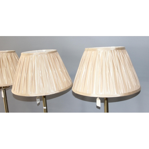 231 - A set of 3 brass effect standard lamps with shades