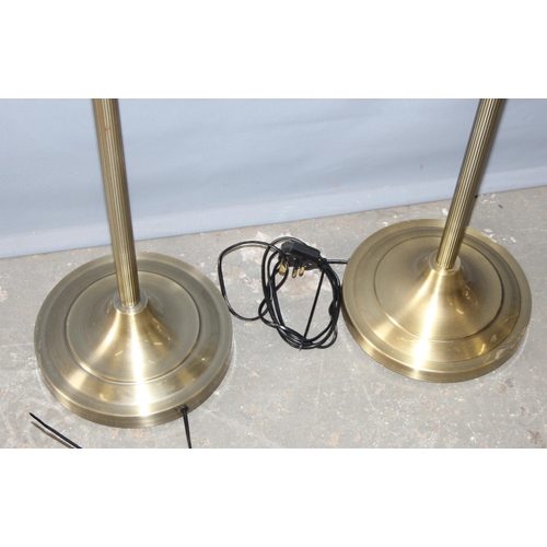 231 - A set of 3 brass effect standard lamps with shades