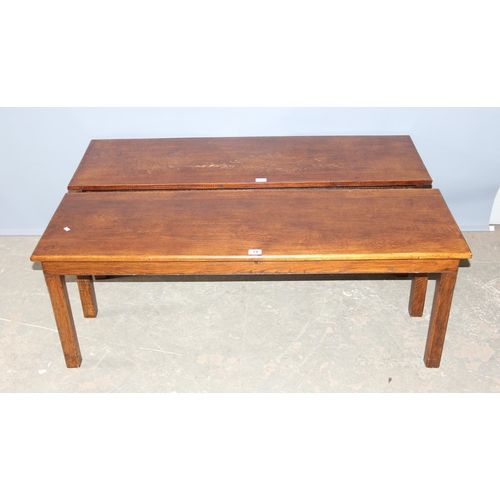 24 - An unusual pair of early 20th century oak low tables, each one forming one half of a square or for u... 