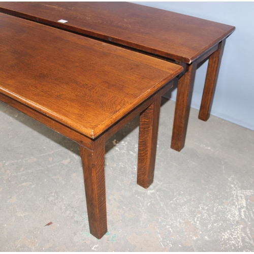 24 - An unusual pair of early 20th century oak low tables, each one forming one half of a square or for u... 