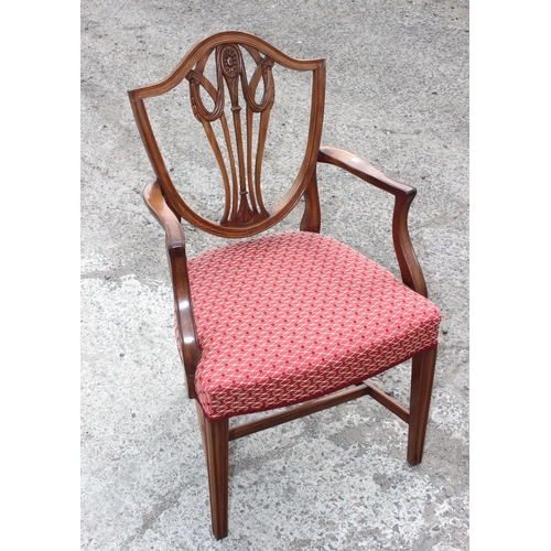 30 - A set of 10 19th century shield backed mahogany dining chairs (2 carver & 8 dining), with patterned ... 