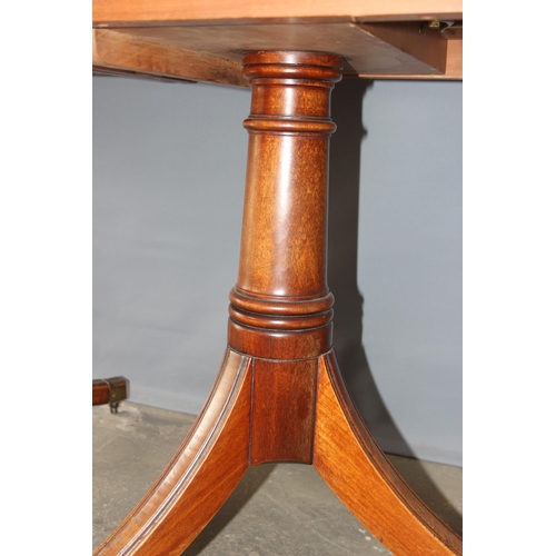 32 - An Edwardian mahogany pedestal tilt topped dining table with extra leaf, approx 230cm x 107cm inc ex... 