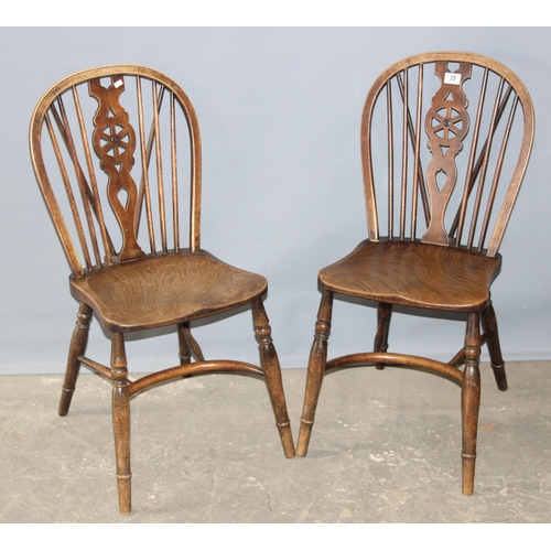 35 - A pair of vintage elm seated wheel back chairs