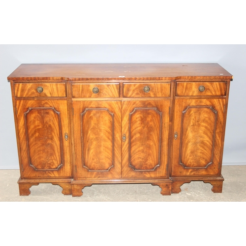 36 - An antique style mahogany breakfront sideboard with 4 drawers over 3 cupboards, approx 155cm wide