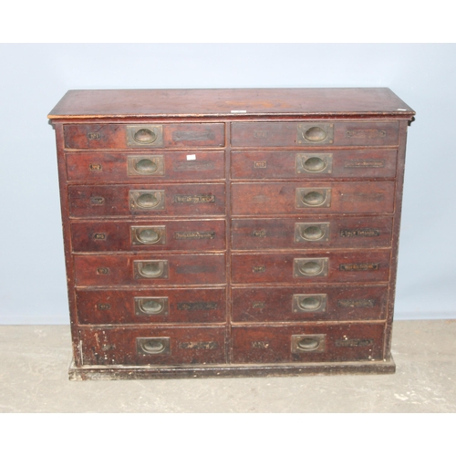 5 - A late Victorian mahogany haberdashery shop bank of fourteen drawers, each graduated drawer with flu... 