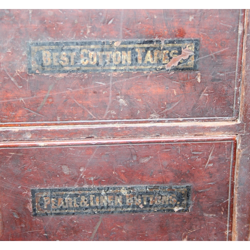 5 - A late Victorian mahogany haberdashery shop bank of fourteen drawers, each graduated drawer with flu... 