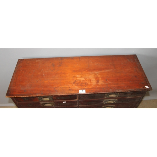 5 - A late Victorian mahogany haberdashery shop bank of fourteen drawers, each graduated drawer with flu... 