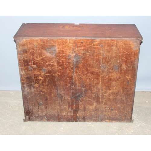 5 - A late Victorian mahogany haberdashery shop bank of fourteen drawers, each graduated drawer with flu... 