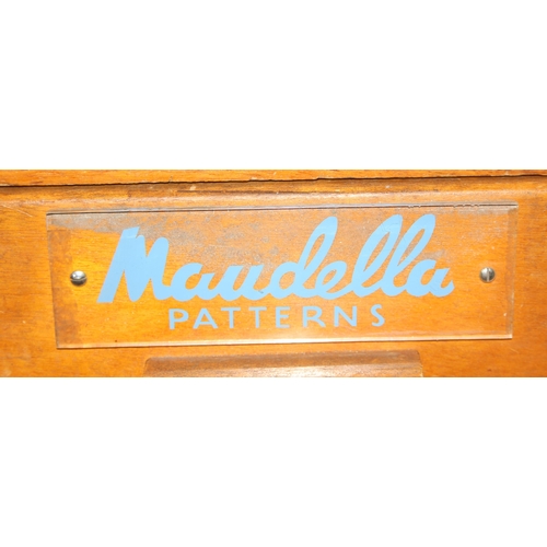 8 - A retro 5 drawer light oak chest of drawers with Maudella Patterns advertising decals, approx 54cm w... 