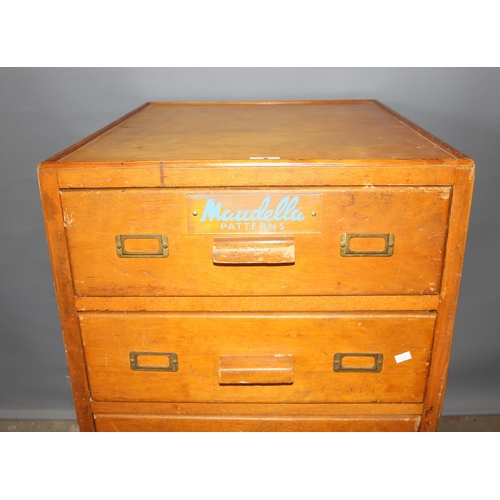 8 - A retro 5 drawer light oak chest of drawers with Maudella Patterns advertising decals, approx 54cm w... 