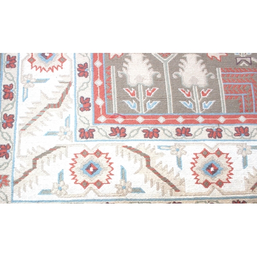 215 - Large cream ground rug with repeat floral decoration, measures approx 240cm 360cm