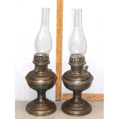 251 - A pair of early 20th century oil lamps with glass shades