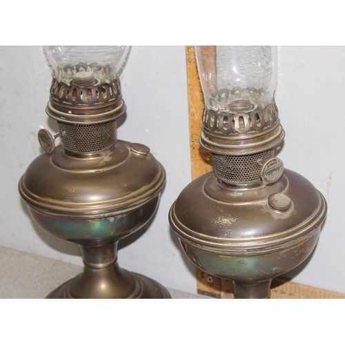 251 - A pair of early 20th century oil lamps with glass shades