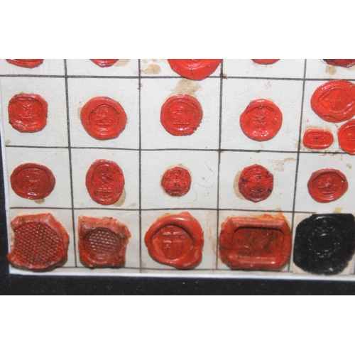 418 - An unusual framed display of antique wax seals, approx 52cm x 43cm