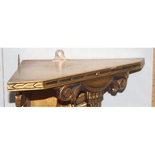 94 - A vintage Florentine style carved gilt wood wall shelf or bracket carved with a brace of snipe or wo... 