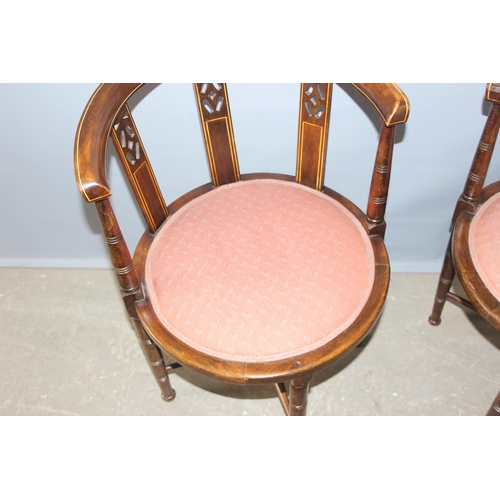 41 - A pair of early 20th century horse shoe shaped backed bedroom chairs with pink upholstered seats