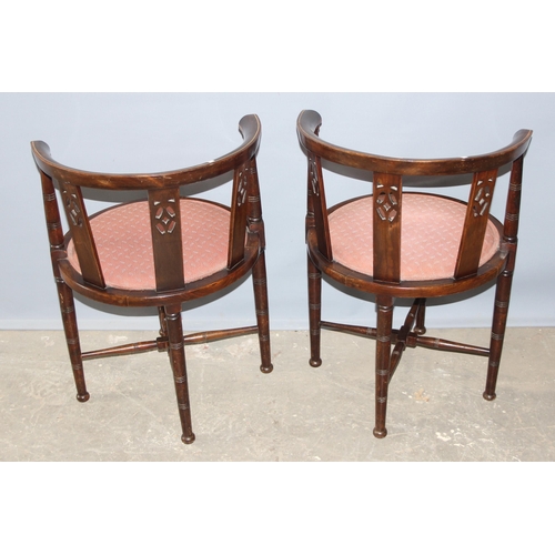 41 - A pair of early 20th century horse shoe shaped backed bedroom chairs with pink upholstered seats