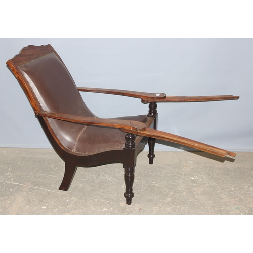 43 - A pair of early 20th century Eastern hardwood plantation chairs, each with lower swivel platform arm... 