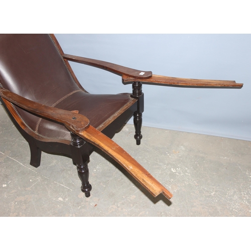 43 - A pair of early 20th century Eastern hardwood plantation chairs, each with lower swivel platform arm... 