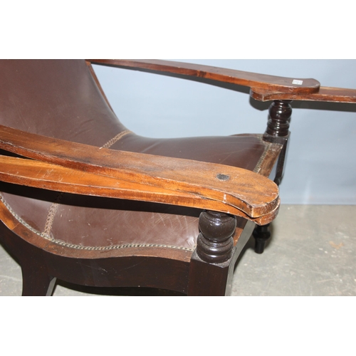 43 - A pair of early 20th century Eastern hardwood plantation chairs, each with lower swivel platform arm... 