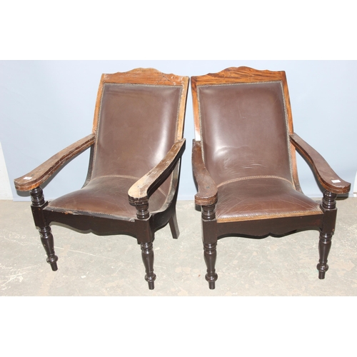 43 - A pair of early 20th century Eastern hardwood plantation chairs, each with lower swivel platform arm... 