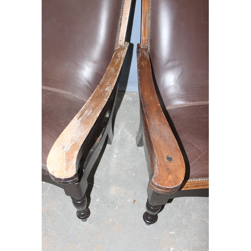 43 - A pair of early 20th century Eastern hardwood plantation chairs, each with lower swivel platform arm... 