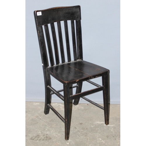 61 - An antique black painted slat back chair